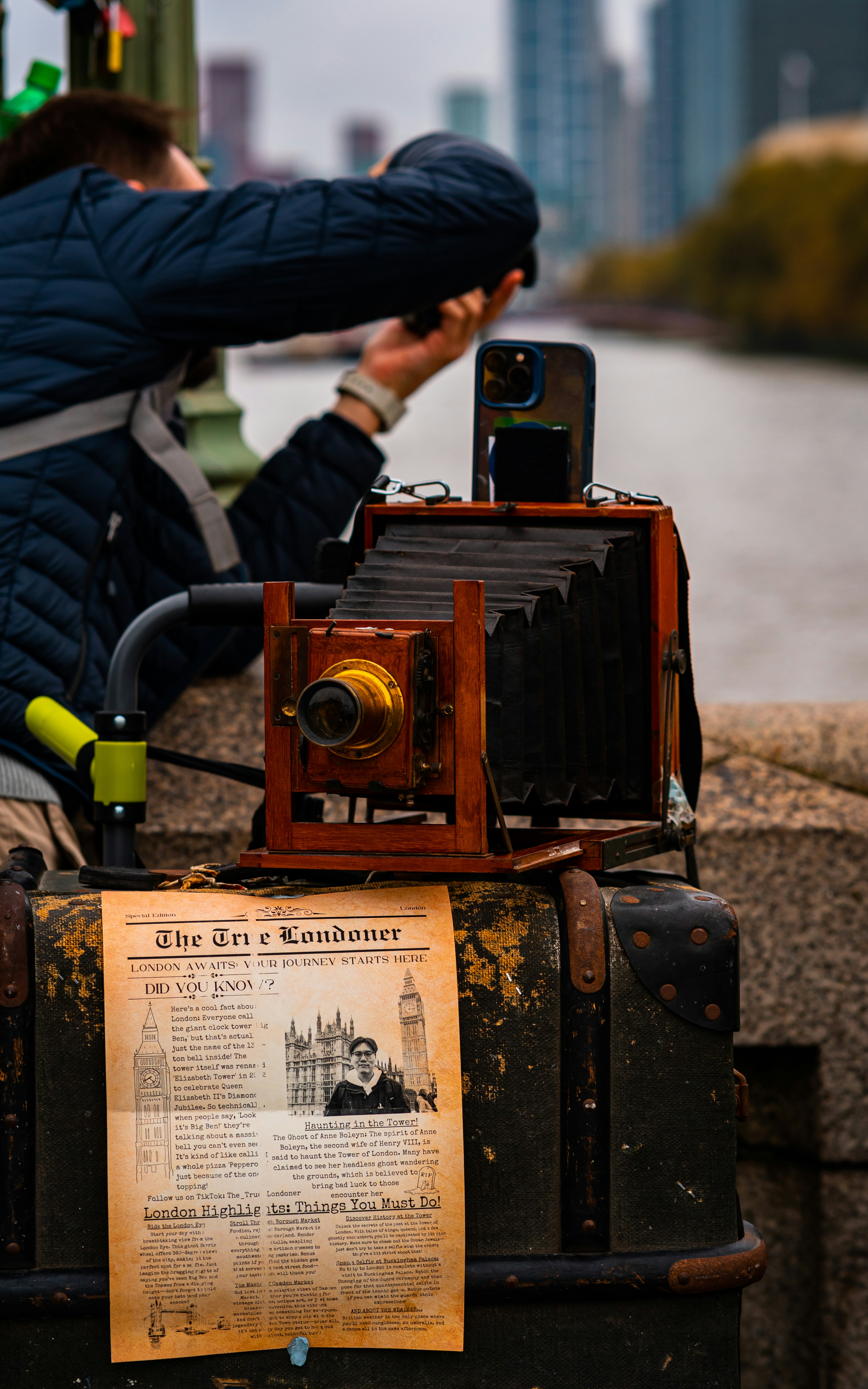 A man taking a picture of an old camera